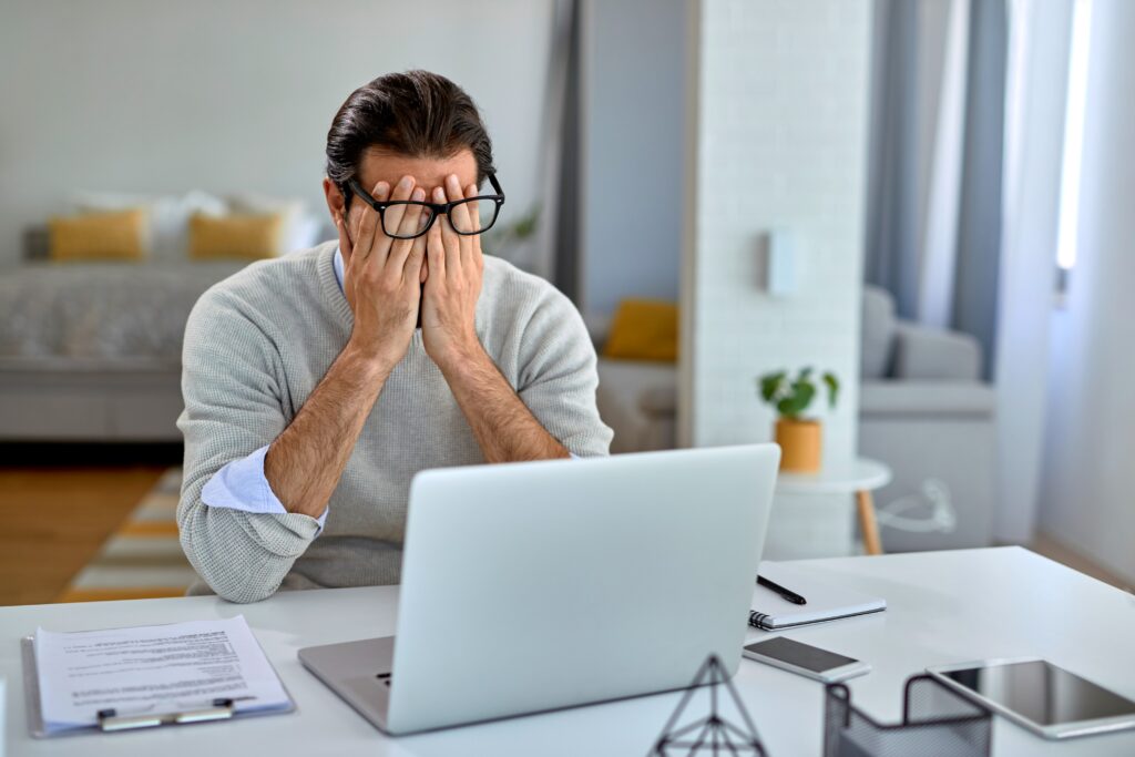 businessman-feeling-exhausted-after-working-laptop-home